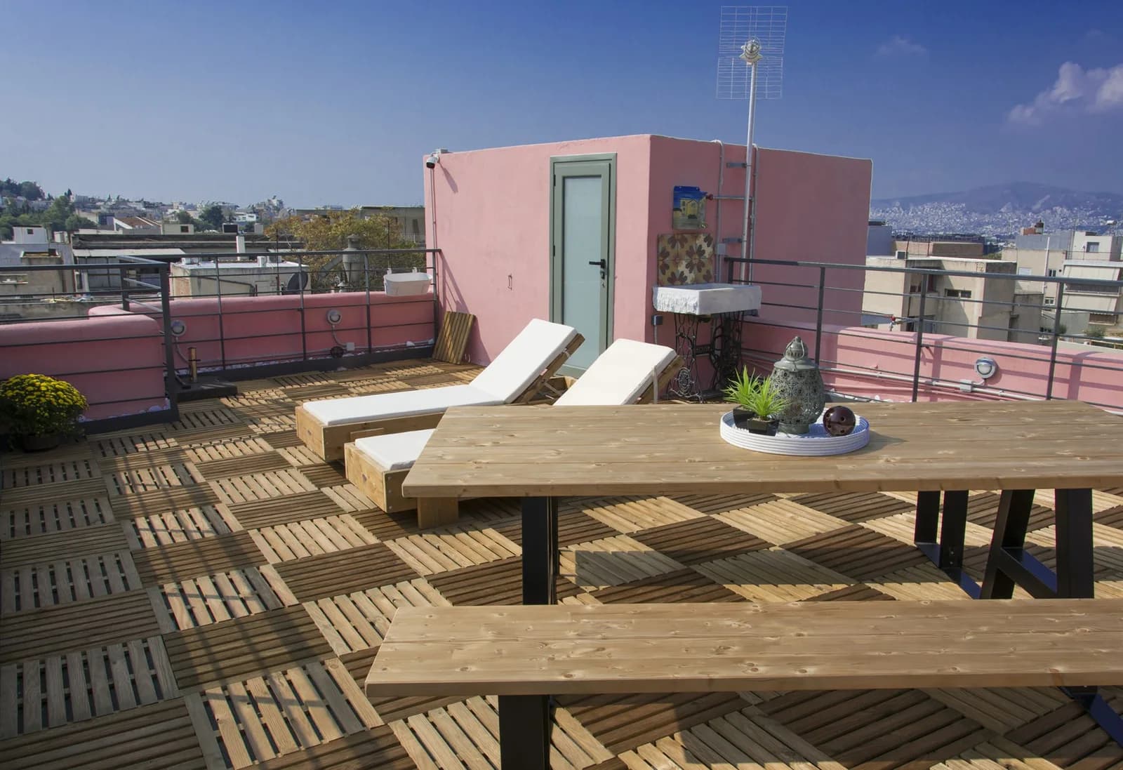 מיטות שיזוף ושולחן על הגג המשותף של Central Stay Athens
